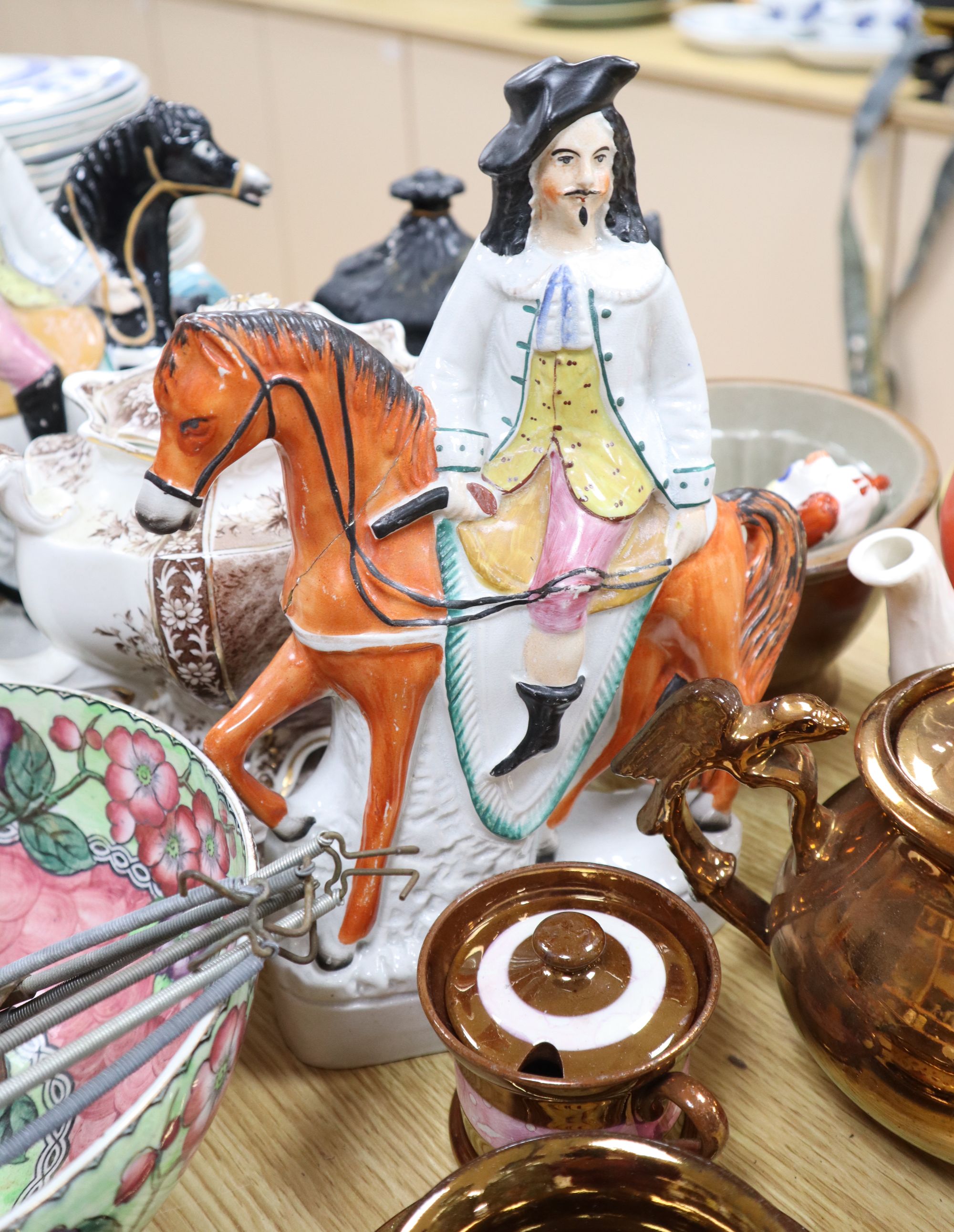 A group of Staffordshire pottery figures, teapots and lustre wares